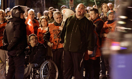 A demonstrator shouts slogans outside the urban bus depot in Madrid, Spain during a general strike.