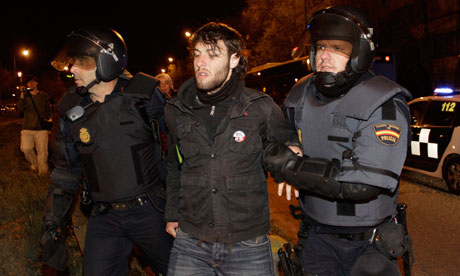 A demonstrator is arrested by police agents after he tried to stop an urban bus in Madrid, Spain.