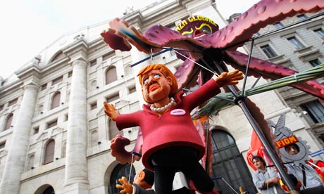 A puppet of German chancellor Angela  Merkel is hung in front of Milan's stock exchange.