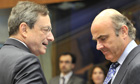 ECB president Mario Draghi (L) speaks with Spanish Finance Minister Luis De Guindos