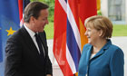 German Chancellor Angela Merkel greets British Prime Minister David Cameron in Berlin, Germany