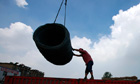 Chinese worker unloading steel bars at a factory in Huaibei, east China's Anhui province