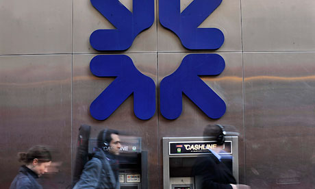 Pedestrians pass a Royal Bank of Scotland branch in London