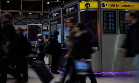 Travellers buy tickets for the Heathrow Airport Express train at Paddington train station