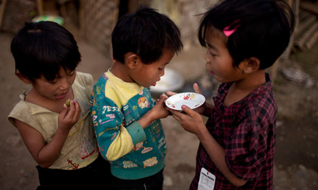 Three children at a camp for displaced people in Burma