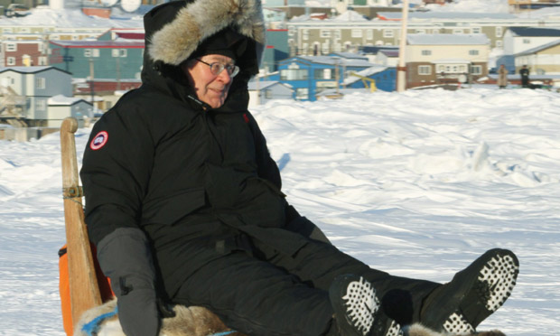 Mervyn King on a dogsled at the G7 meeting in Canada, 2010