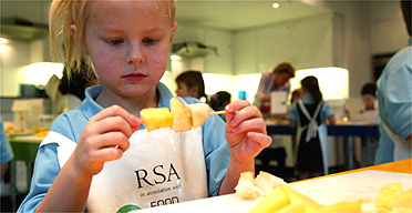 Schoolchildren learn to make tropical fruit kebabs