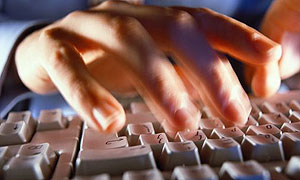 Man typing on a computer keyboard