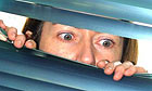Parents spying on their children through a venetian blind