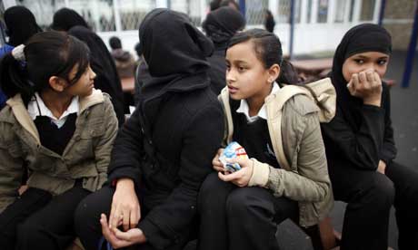 Pupils, some wearing Muslim headscarves, in the playground at Grange School in Oldham