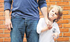 Child attached to parent's leg