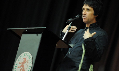 Johnny Marr, with accompanying gladioli, gives his first lecture at University of Salford