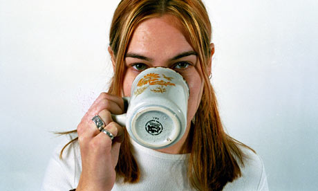 A woman drinking a cup of coffee