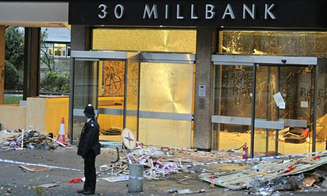 Lone policeman surveys Millbank damage after demo