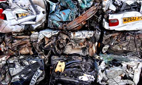 Crushed cars squashed into a huge pile 