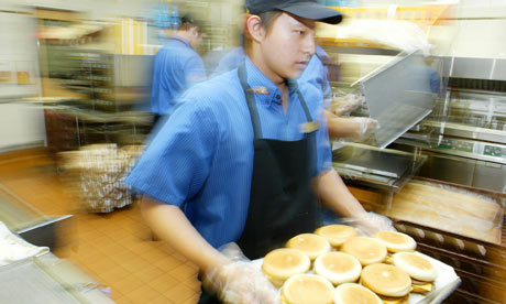 Wilsen Lau, 19, prepares burgers at the McDonalds restaurant in Kingsford, Sydney