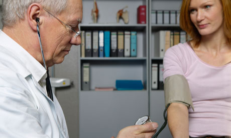 Doctor takes patient's blood pressure