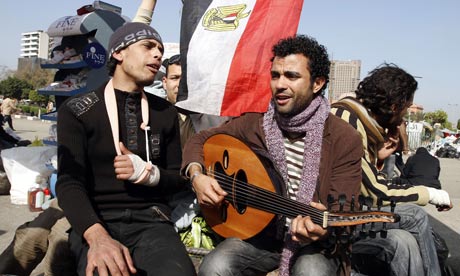 Egyptian demonstrators sing protest songs in Cairo's Tahrir Square in February 2011