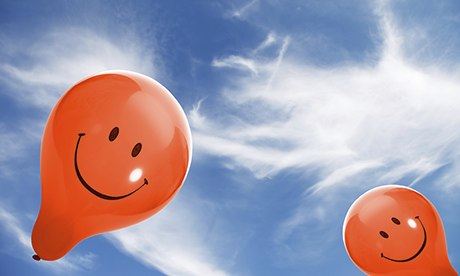 smiley face balloons in blue sky