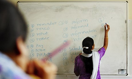 woman writing words on a whiteboard