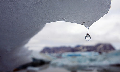 An iceberg melts, drips water in Kulusuk Bay, eastern Greenland