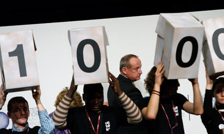COP15 UN Climate Chief Yvo de Boer walks past members of the environmentalist group TckTckTck