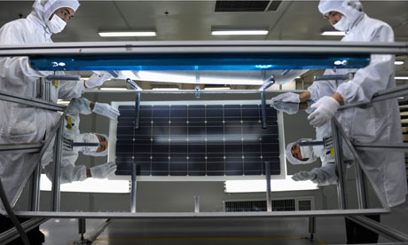 China solar industry : Employees inspect solar panels at a workshop in factory in Hangzhou
