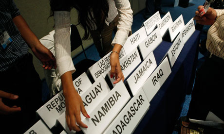 Climate change conference in Cancún, Mexico A woman hands out names of countries to participants at the United Nations climate change conference in Cancún, Mexico
