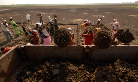 MDG: NREGA Labourers load a truck as they try to revive a dried lake in Ibrahimpatnam