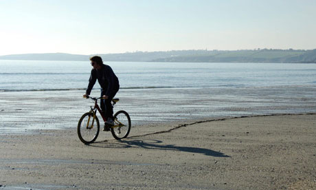 Bike Blog: Mountain bike rider on beach in Cornwall