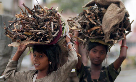 MDG : Indian girls carry wood sticks back home for cooking  in Amritsar,