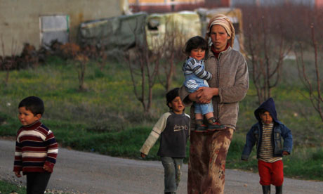 MDG : International Women's Day : Syrian woman Khadija walks with her children, Lebanon
