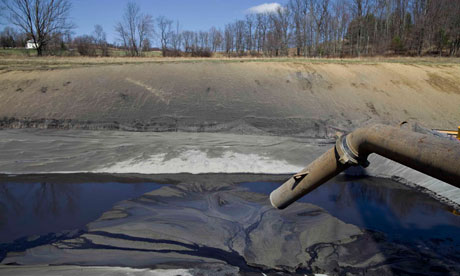 Shale Gas : A pipe leads to a lined pit used to collect drill cuttings, Pennsylvania