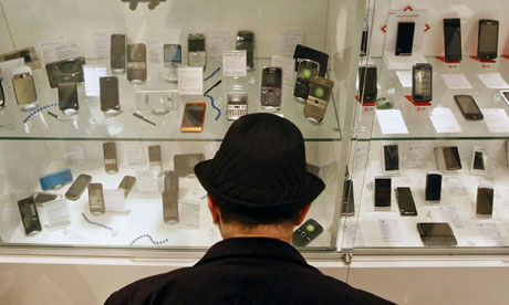 Leo Blog : green mobile phones , a customer browses mobile handsets in a shop