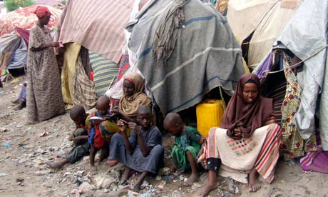 MDG : Somalia : Somalis frefugees so sit outside their makeshift home in Mogadishu
