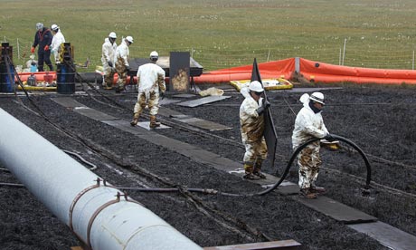 Workers clean up an oilspill at BP Pudhoe Bay oil fields in Alaska 