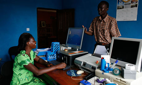 MDG : Woman using a computer in a school office in Calaba town near Freetown, Sierra Leone