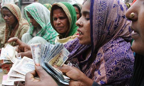 MDG : Microfinace : Bangladeshi Women Count Money or repayment to a microcredit bank