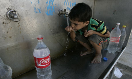 Water in Gaza : A Palestinian boys drinks water from a public tap in Gaza