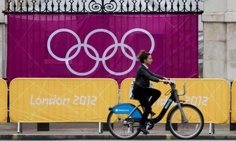 Bike blog : a woman rides Barclays Bank-sponsored 'Boris' bicycle during London 2012 Olympics