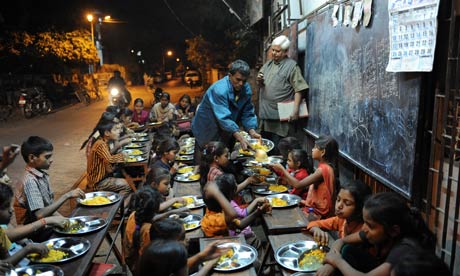 MDG : Teachers and education : teacher Kamalbhai Parmar watches students eat dinner in Ahmedabad 