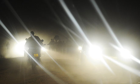 MDG : Road safety in Kenya : A man rides a motobike at night
