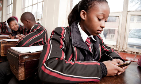 MDG : Games for cellphones : A female student playing with her cellphone in class