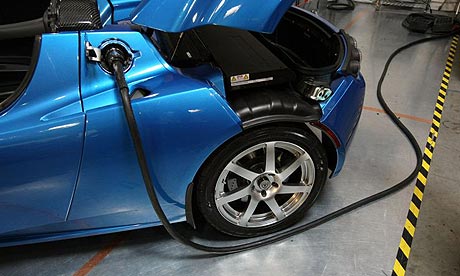 Electric  Photo on Power Cable Is Seen Plugged Into A Tesla Roadster Electric Car In