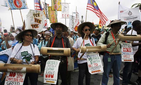 Activists hold banners during a demonstration outside the United Nations Building in Bangkok