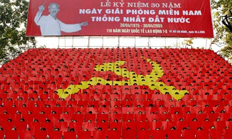 Vietnamese youths display the communist emblem during a parade in Ho Chi Minh City