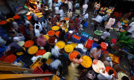 Vendors sell flowers at a wholesale flower market in Mumbai, India