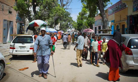 Somalis walk to and from Hamar Weyne market in the capital, Mogadishu