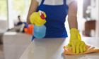 Woman cleaning kitchen counter