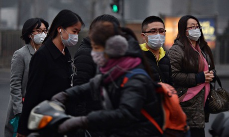Chinese commuters wear face masks as heavy air pollution continues to shroud Beijing